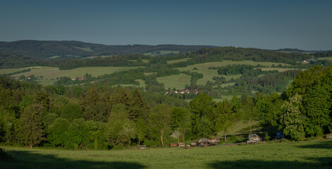 Summer hot morning with green meadows and forests in Sumava mountains