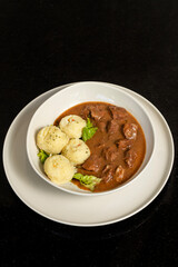 Veal with sauce prepared in a modern style, served with mashed potatoes in an elegant presentation. A delicious dinner.