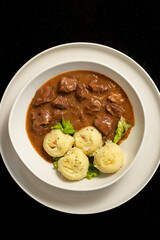 Veal with sauce prepared in a modern style, served with mashed potatoes in an elegant presentation. A delicious dinner.