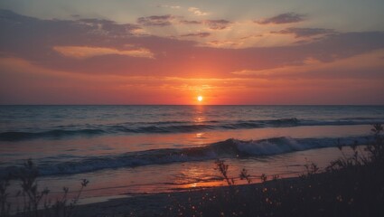 Obraz premium Sunset over the ocean with vibrant colors and calm waves. Coastal scene during twilight, showcasing the beauty of nature's evening transition.