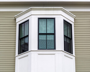 Architectural detail of a black-framed bay window on building exterior in Brighton, Massachusetts, USA
