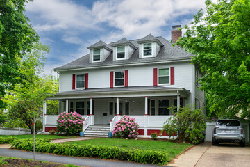 Charming two-story suburban home with classic architectural details on a spring day in Newton,...