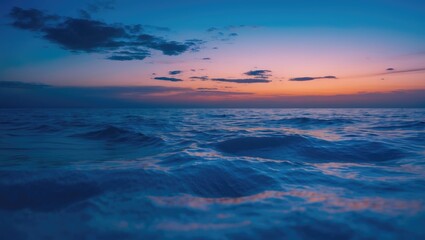 Fototapeta premium Ocean waves at sunset with colorful sky and clouds. Nature and seascape. The calmness of the sea during twilight. The scene of the ocean at dusk.