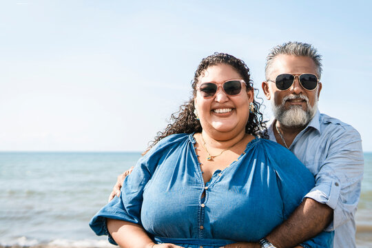 Happy couple embracing on beach, enjoying sunny day together