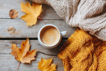 Cozy autumn vibes with a cup of coffee surrounded by colorful leaves and warm textures