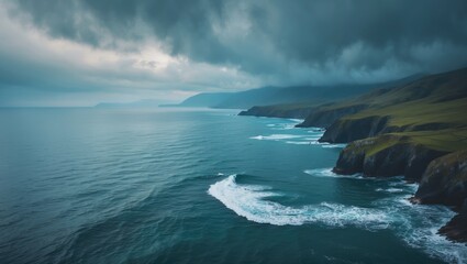 Aerial view of rugged cliffs and rolling waves along a coastline under stormy clouds. Nature and landscape, ocean, cliffs, weather. The scenery of a rugged coastline with storm clouds overhead