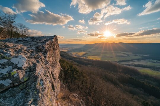 Fototapeta Sunset over a breathtaking landscape with rocky cliffs and vibrant clouds, Beautiful nature video time lapse landscape Big sun close-up rising at mountain