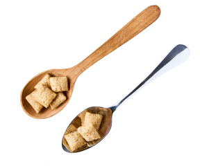 corn pads in a metal spoon isolated on white background, top view.