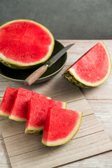 Slices of fresh watermelon on bright rustic wooden table