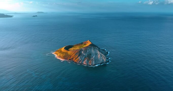 Beautiful bare island surrounded by the Pacific Ocean. Aerial perspective on the Rabbit Island near Oahu, Hawaii, USA.
