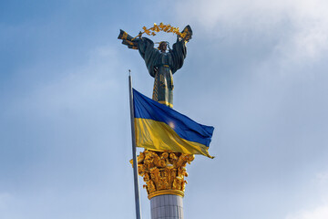 Independence monument and ukrainian flag in Kyiv. Ukraine