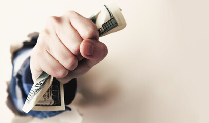 Money concept. US Dollar bills in hand as a symbol of success and power. Copy space. Horizontal image.