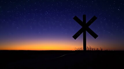 Silhouette of a railway crossing sign under the starlit sky and subtle lighting on the horizon