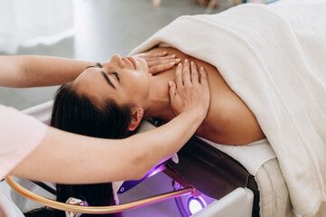 Scalp spa treatment with long dark hair on spa couch, professional hair therapy session