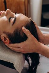 Scalp spa treatment with long dark hair on spa couch, professional hair therapy session