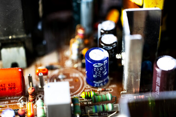 Close-up of an old circuit board with various electronic components. Visible capacitors, resistors,...