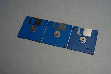 row of three blue 3.5-inch floppy disks.