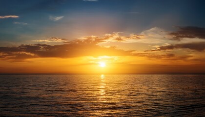 Fototapeta premium stunning golden sunrise over the calm sea horizon