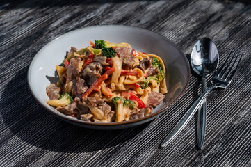 Pasta with beef, mushrooms and vegetables. 