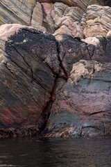 rugged coastal rock formations with dark and weathered surfaces.