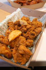 Korean deep dried chicken in paper brown take out box.