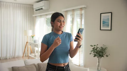 Gordijnen Asia young adult black people humor bizarre funny dance good news at home living room happy joy job hired interview result on mobile, award bonus, win luck bet online game order trade, loan money. © ChayTee