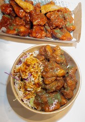 Korean deep dried chicken on white rice with soy garlic sauce.