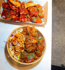 Korean deep dried chicken on white rice with soy garlic sauce.