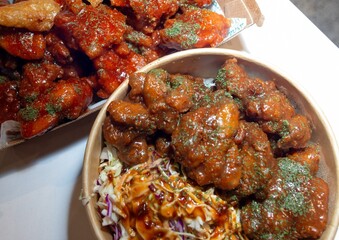 Korean deep dried chicken on white rice with soy garlic sauce.