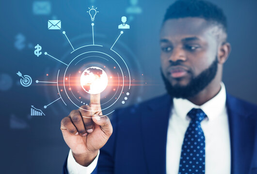 Analytics and monitoring of world economics and business management. Serious african american man with beard clicks on virtual planet button on digital screen with icons, double exposure, collage