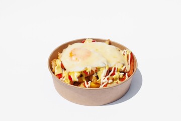salchipapas with fried egg - popular latino street food dish in Peru and Colombia - hot dogs and French fries, served with sauces like ketchup. Latin American cuisine on white background.