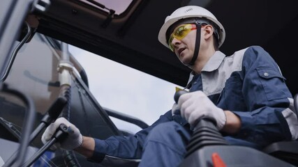 Man driver builder operate crane or excavator at construction site with sun light. Portrait Industry worker. - Powered by Adobe