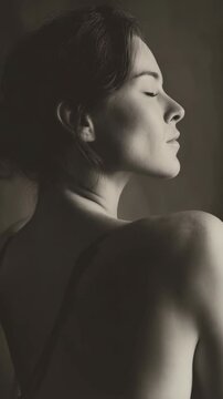 Monochrome portrait of a contemplative woman with eyes closed in a serene mood and smooth skin with a neutral background, studio shot