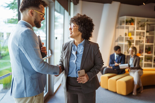 African american businesswoman handshake with caucasian man colleague