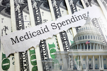 Medicaid newspaper headline on hundred dollar bills with US Capitol