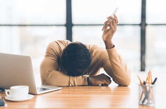 Feeling Exhausted. Frustrated black man resting head on his hand after difficult conversation on phone. Free space