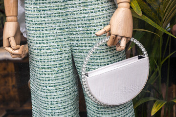Stylish white bag with a dazzling handle.