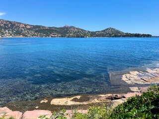Clear coastal view of the French Riviera with deep blue sea, transparent water, coastal vegetation...