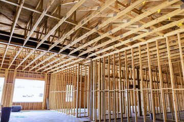 Workers are building new interior with visible wooden framing ceiling supports in works day