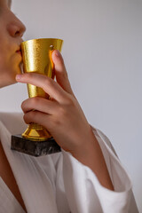 Golden trophy in hand, representing accomplishment and excellence, winning and reward, triumph and...