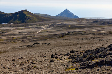 Iceland. Vast, barren terrain stretches across Islandia, showcasing rocky features and hills under...