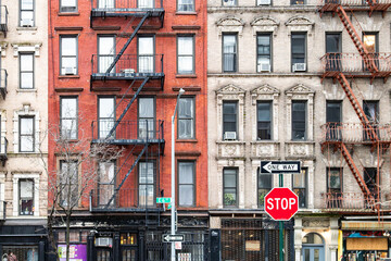 Stop sign on 6th Street in front of historic old apartment buildings in the East Village neighborhood of New York City