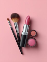 A collection of makeup products including a lipstick, eye brush, ballpoint brush and two other types of makeup brushes on a pink background. 