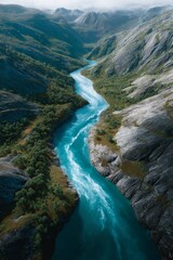 Obraz premium A winding river in a mountainous landscape, with clear water and green vegetation around its banks.