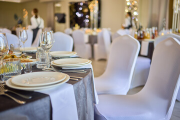 An Elegant Event Venue featuring Candlelit Centerpieces and Exquisitely Refined