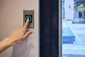 Hand Pressing a Modern Elevator Button That Features a Green Light Indicator for Operation © Евгений Вершинин