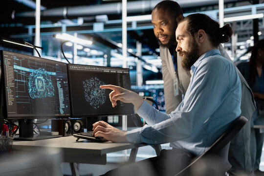 Team of technicians using PC in data center, integrating AI driven automation tools, doing maintenance. Server farm coworkers using artificial intelligence machine learning models