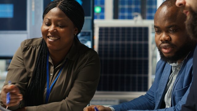 Factory management presents business models to businessmen, expanding production. Shareholders discuss integrating automation technology in industrial plant, looking at equipment options, camera B