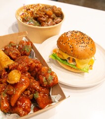 Korean deep dried spicy red chicken sauce in a paper takeaway box.