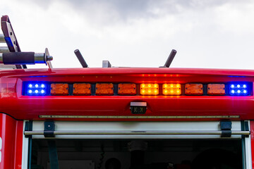 Flashing blue and amber warning lights on the roof of a fire truck.